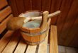 Holzeimer voll mit Wasser mit Schöpfkelle