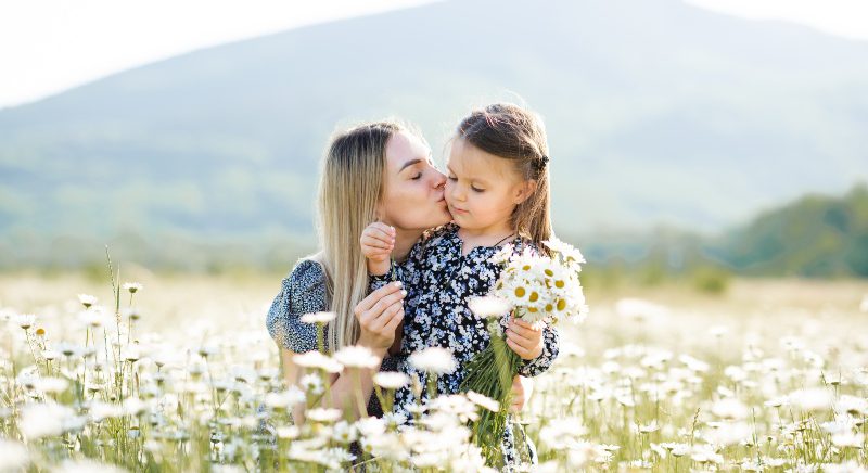 Mutter-mit-Tochter-in-einem-Feld-voll-Mutterkraut